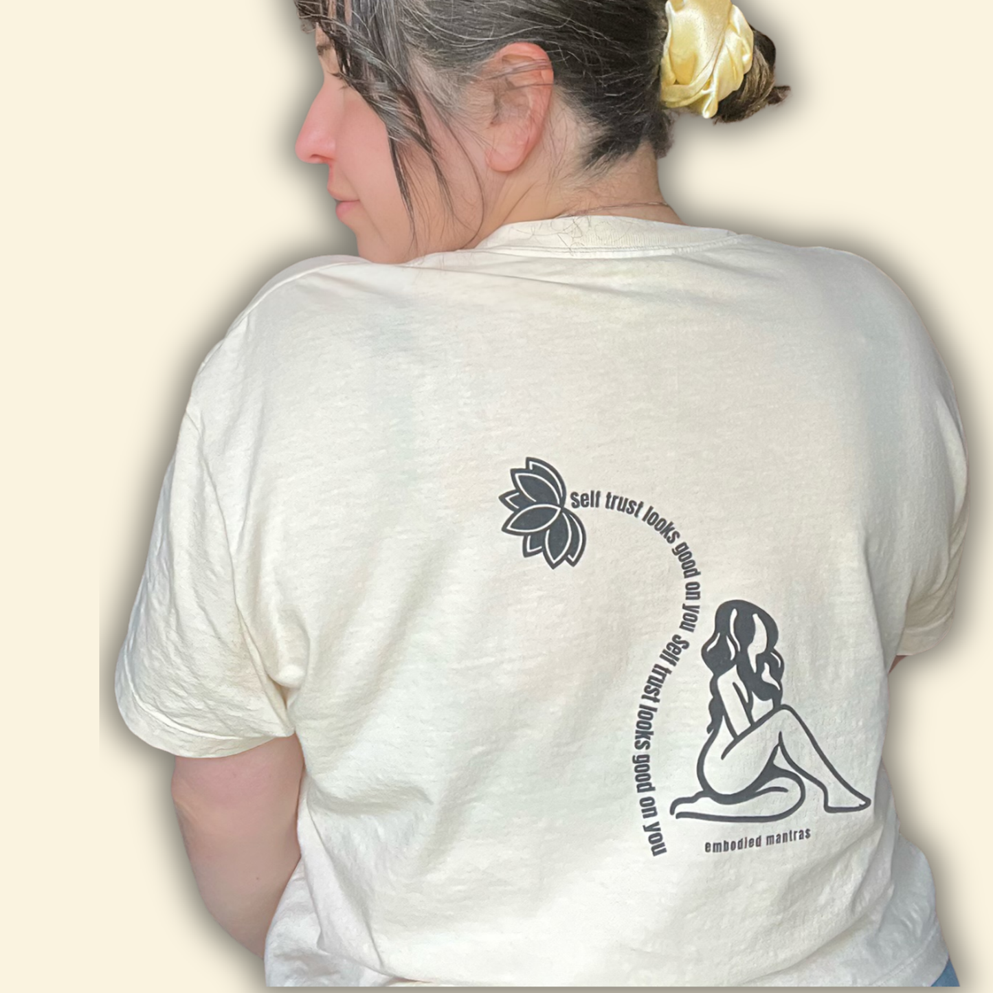 Person wearing a white t-shirt with graphics and text on the back